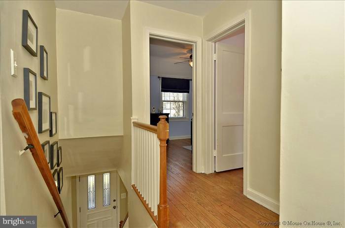 5512 Northfield Road Bethesda, MD 20817 - Photo 27 of 29 a view of a hallway with wooden floor and staircase