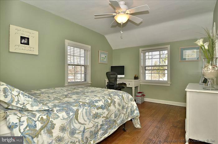 5512 Northfield Road Bethesda, MD 20817 - Photo 5 of 29 a bedroom with a bed and a chandelier