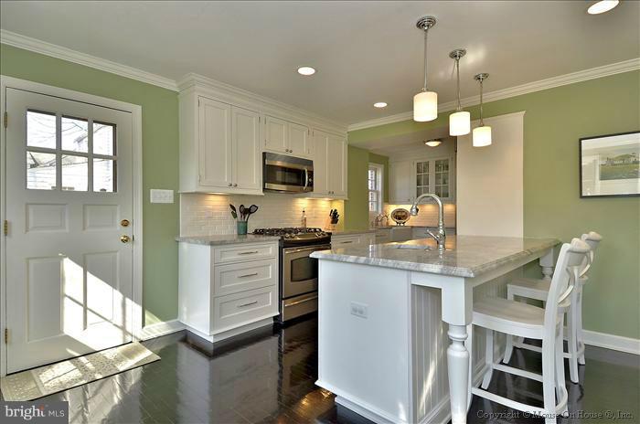 5512 Northfield Road Bethesda, MD 20817 - Photo 8 of 29 a kitchen with kitchen island granite countertop wooden cabinets and refrigerator