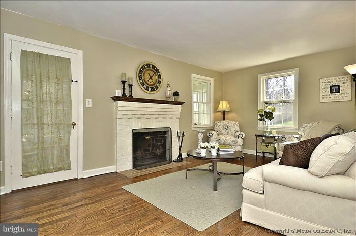 5512 Northfield Road Bethesda, MD 20817 - Photo 9 of 29 a living room with furniture and a fireplace