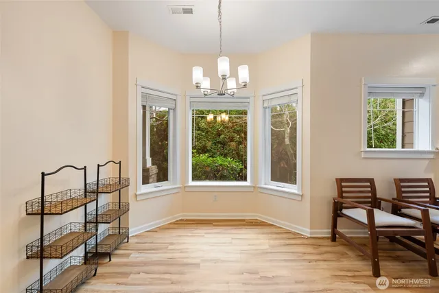 a view of a livingroom with furniture window and wooden floor
