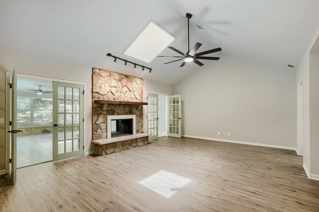 2021 Irwin Bridge Road Northwest Conyers, GA 30012 - Photo 19 of 43 wooden floor in an empty room with a fireplace
