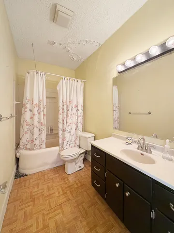 a bathroom with a sink toilet double vanity and shower