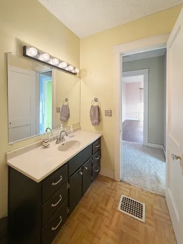 a bathroom with a sink vanity and a mirror