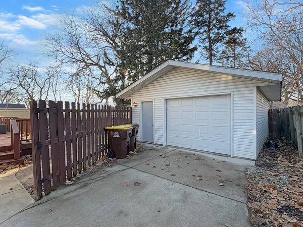 a view of a house with wooden fence