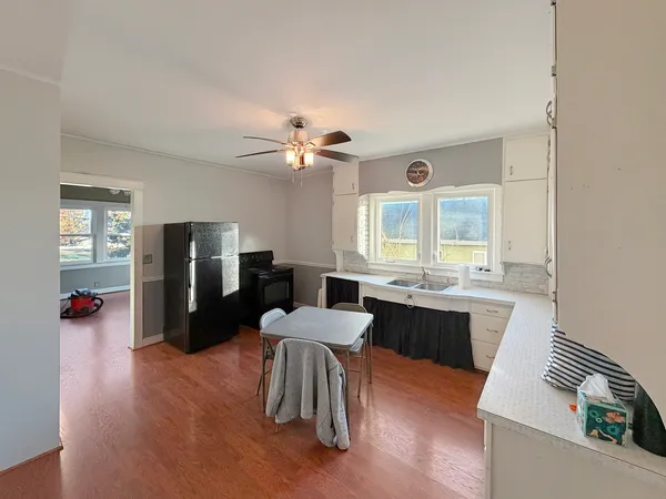 a large kitchen with a table and chairs