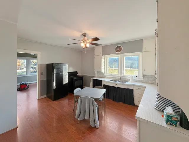 a large kitchen with a table and chairs