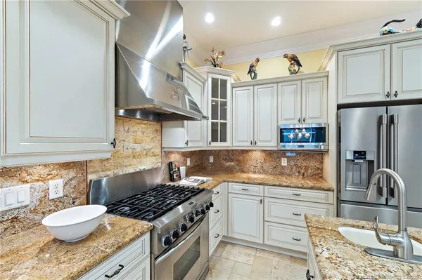 a bathroom with a granite countertop shower a mirror and a bathtub