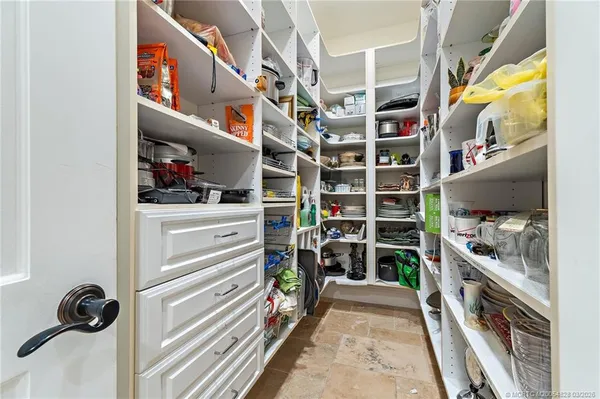 a view of a hallway with wooden floor and windows