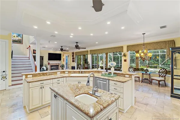 a view of a livingroom with furniture hardwood floor and a ceiling fan