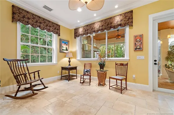a living room with furniture and a book shelf