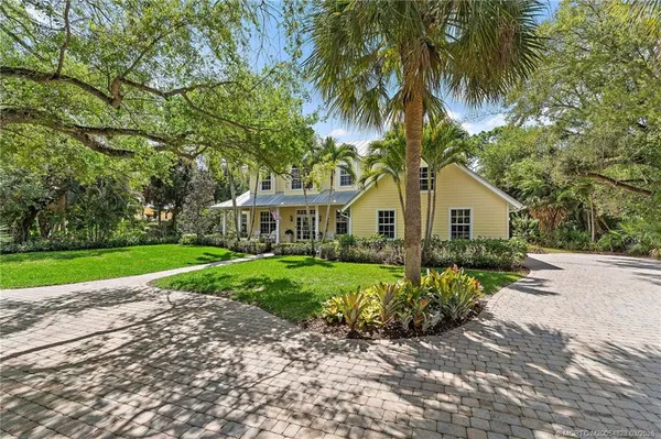 a backyard of a house with plants and tree