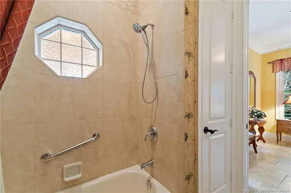 front view of a house with a large window and potted plants