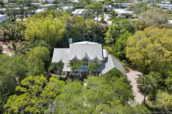an aerial view of a house with a yard