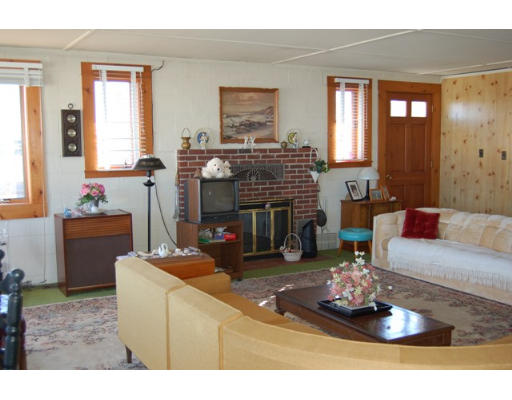 32 Appomattox Road Ipswich, MA 01938 - Photo 4 of 8 a living room with furniture and a fireplace