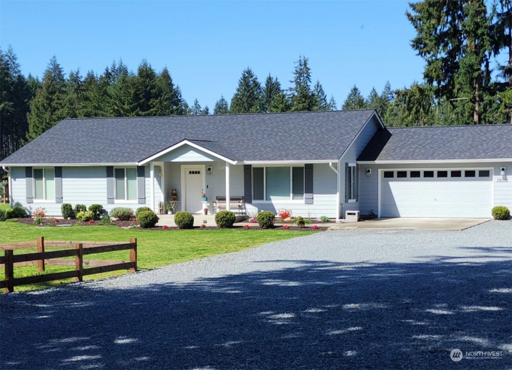 19312 Patterson Road East Orting, WA 98360 - Photo 1 of 39 a front view of a house with a yard table and chairs