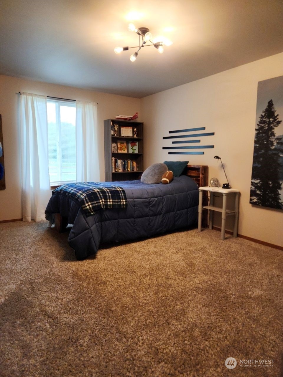 19312 Patterson Road East Orting, WA 98360 - Photo 19 of 39 a large bedroom with a bed and a chandelier