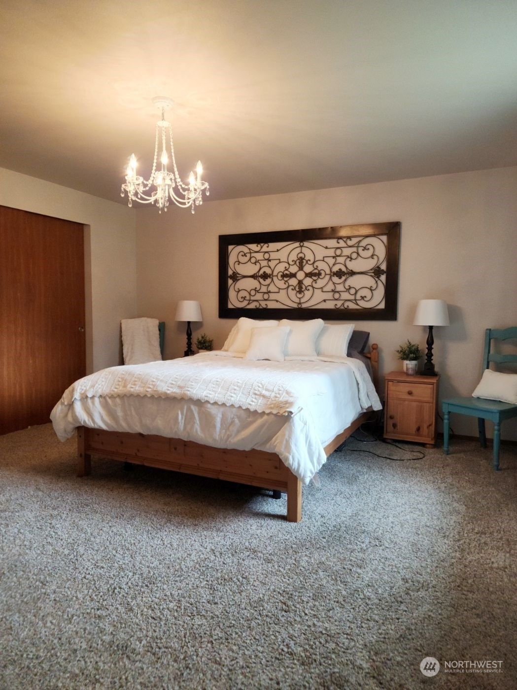 19312 Patterson Road East Orting, WA 98360 - Photo 21 of 39 a bedroom with bed and a chandelier