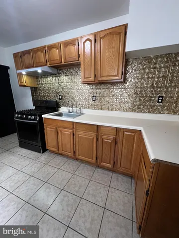 a kitchen with stainless steel appliances a sink and cabinets