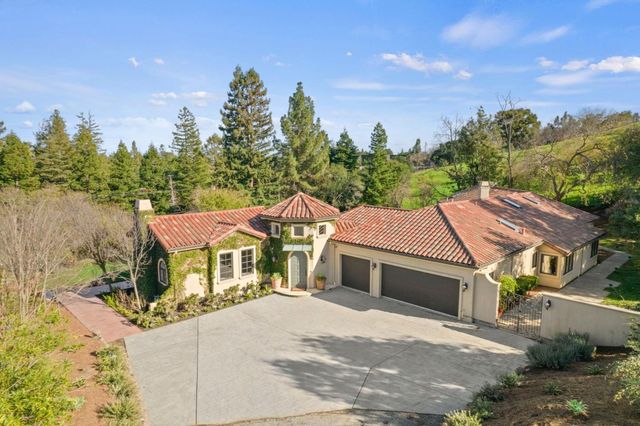 a dining room with chandelier and wooden floor