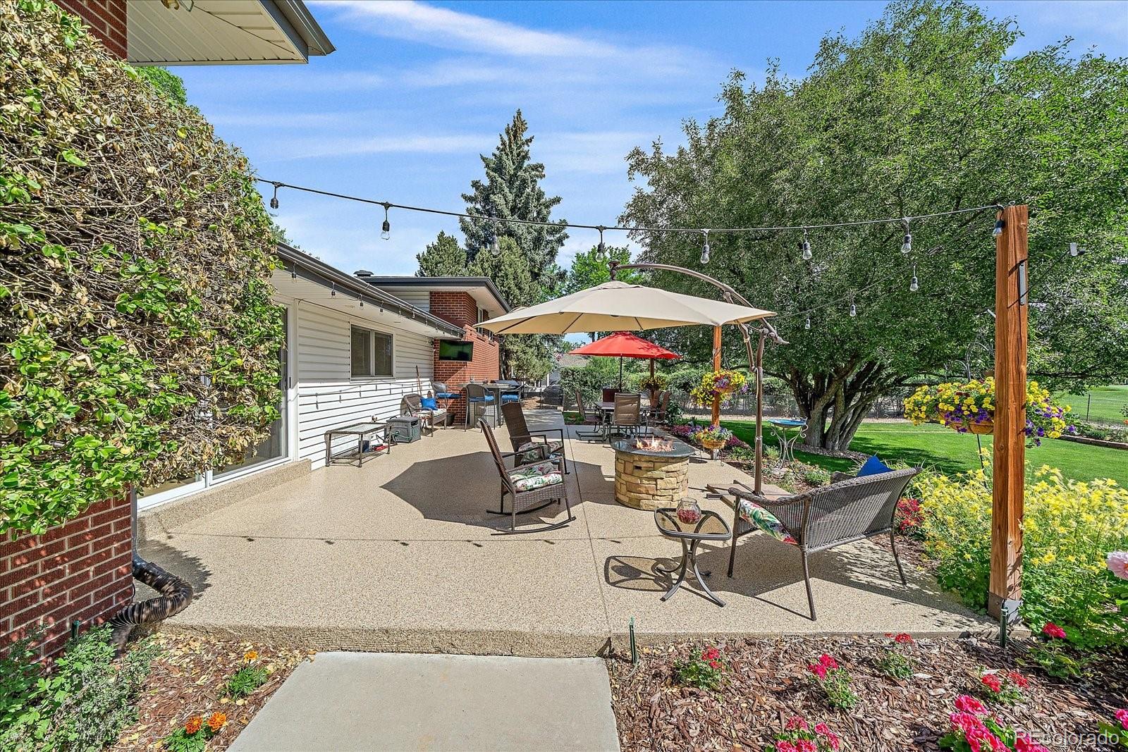 930 Reed Court Lakewood, CO 80214 - Photo 34 of 41 a view of a patio with table and chairs under an umbrella