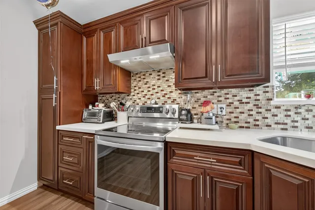 a kitchen with granite countertop cabinets and window