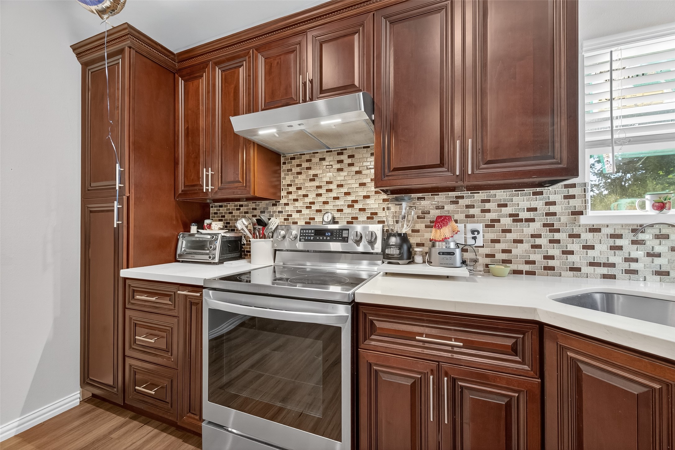 1619 Dolores Street Rosharon, TX 77583 - Photo 14 of 31 a kitchen with granite countertop cabinets and window