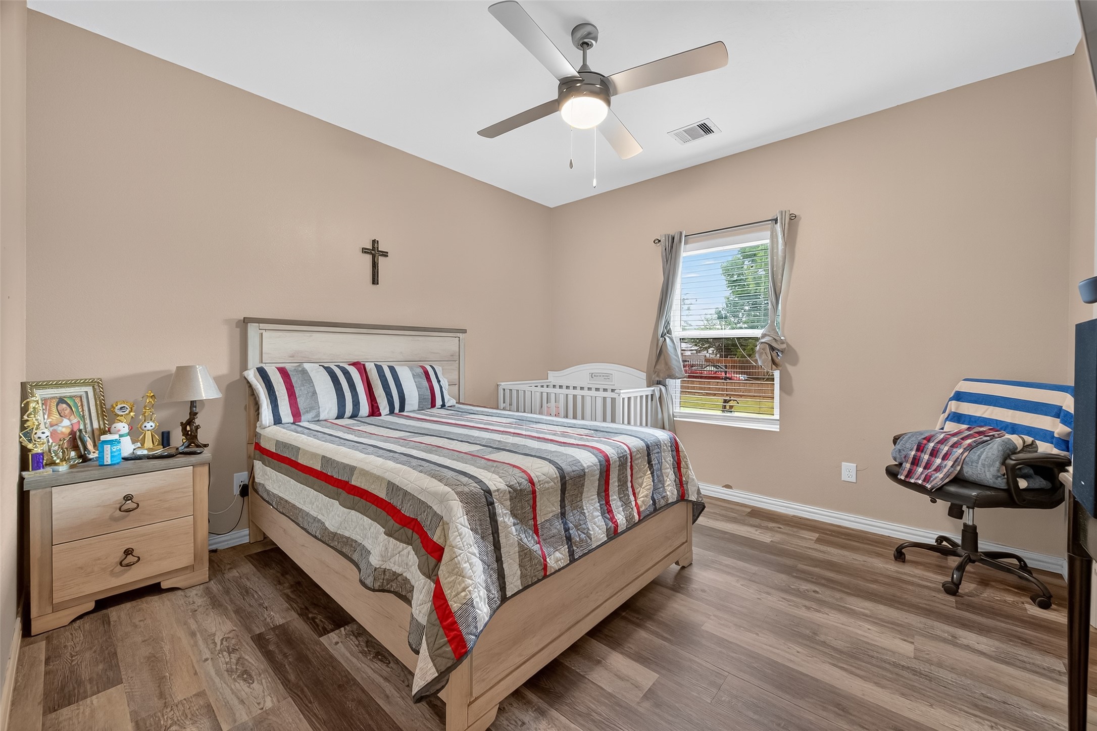 1619 Dolores Street Rosharon, TX 77583 - Photo 18 of 31 a bedroom with a bed and a chandelier