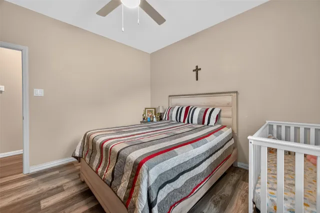 a bedroom with bed and a chandelier