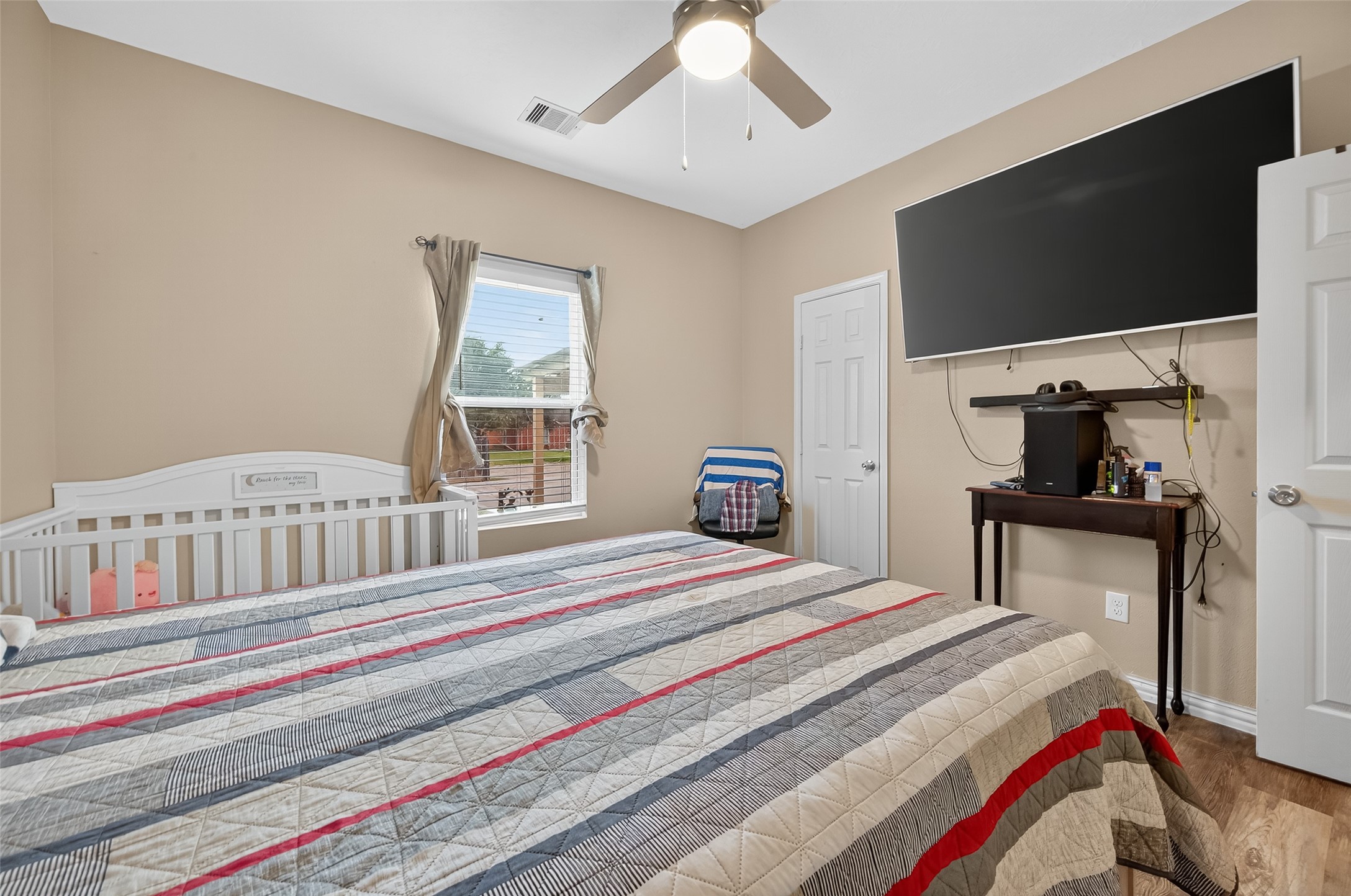 1619 Dolores Street Rosharon, TX 77583 - Photo 20 of 31 a bedroom with a bed and a flat screen tv