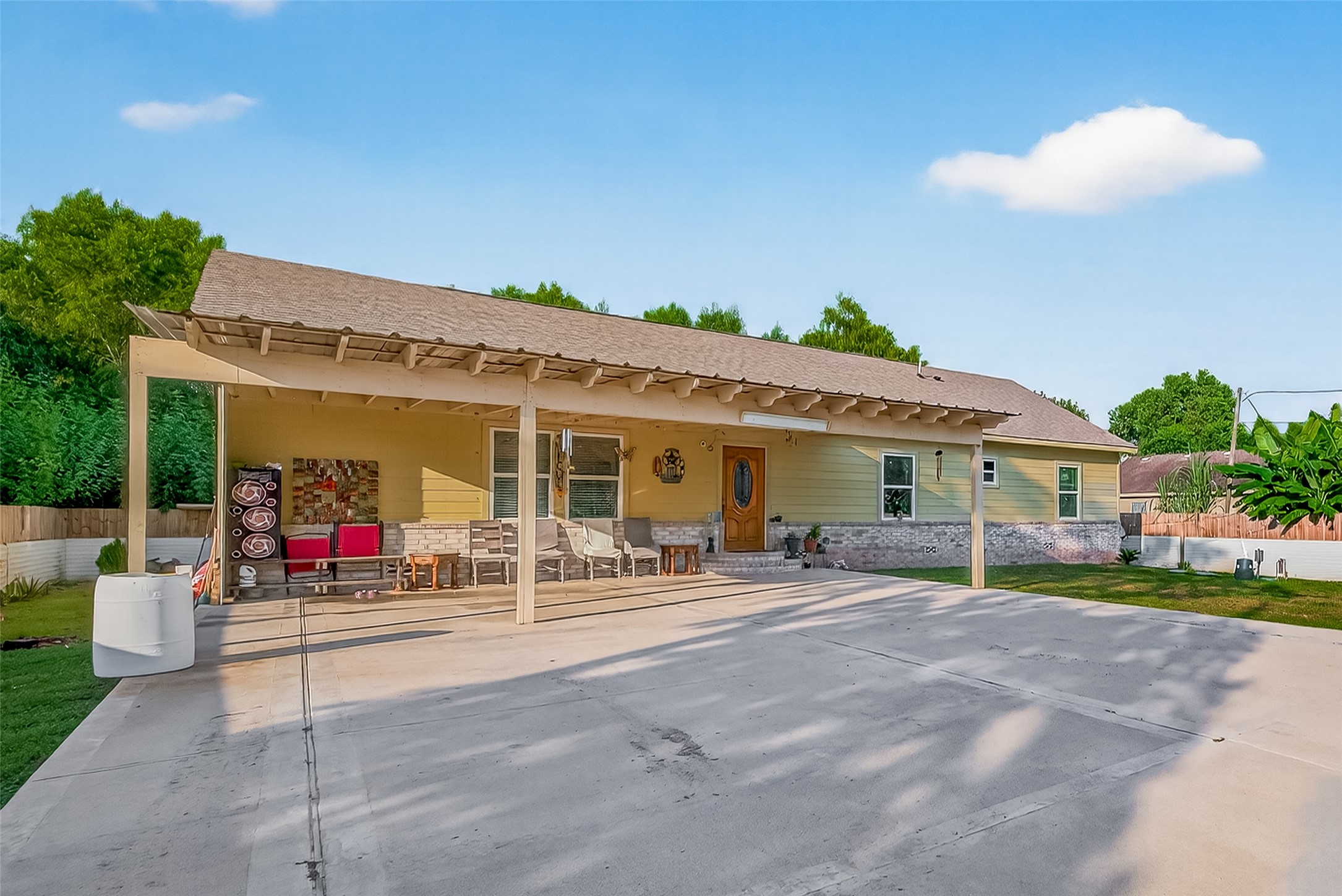 1619 Dolores Street Rosharon, TX 77583 - Photo 2 of 31 a view of a patio with a table and chairs and potted plants