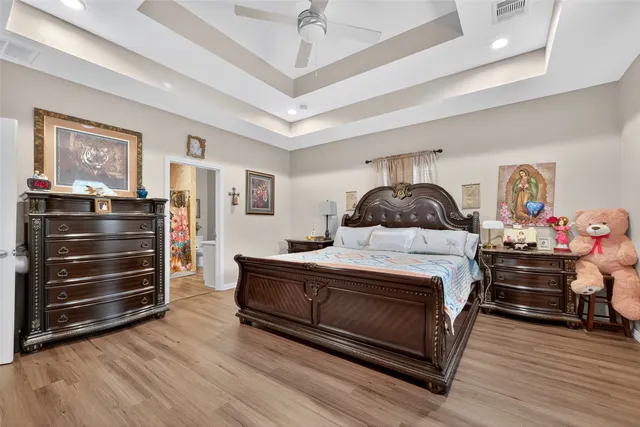 a bedroom with a bed and wooden floor