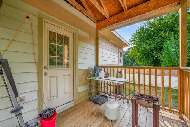 a balcony with table and chairs