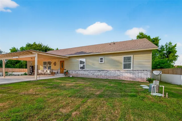 a view of a house with a yard and sitting area