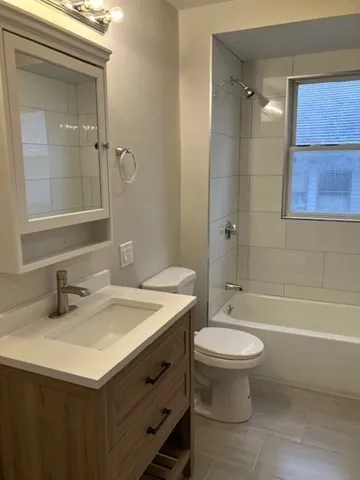 a bathroom with a sink toilet tub and shower