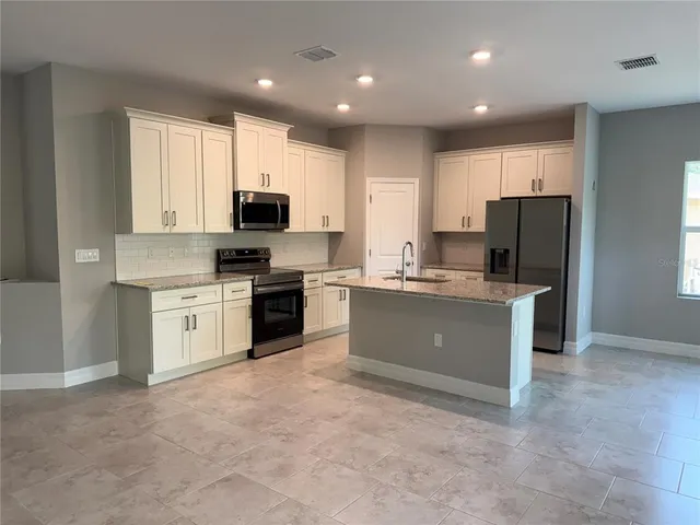 a kitchen with a cabinets and white appliances
