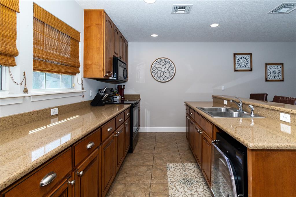 3305 Schoolhouse Road St. Cloud, FL 34773 - Photo 31 of 83 a kitchen with a sink and a stove