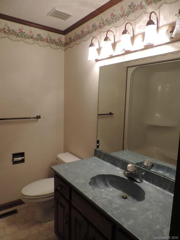 225 Woodridge Road Mooresville, NC 28115 - Photo 18 of 23 a bathroom with a sink and a mirror