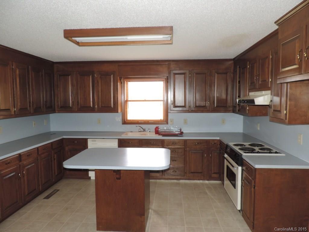 225 Woodridge Road Mooresville, NC 28115 - Photo 3 of 23 a kitchen with a sink cabinets and window