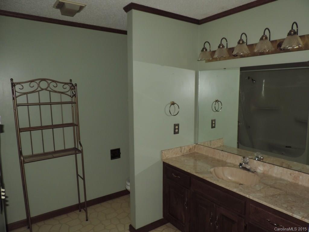 225 Woodridge Road Mooresville, NC 28115 - Photo 7 of 23 a bathroom with a sink and mirror