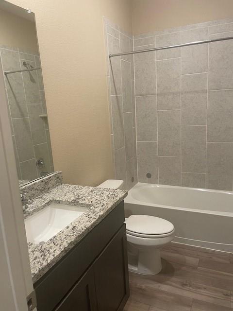 205 Lake Ridge Princeton, TX 75407 - Photo 11 of 13 Full bathroom featuring vanity, shower / washtub combination, dark wood-type flooring, and a textured wall
