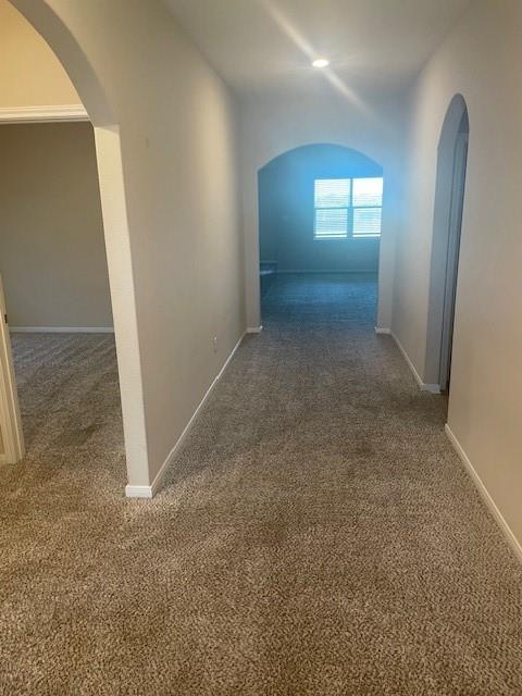 205 Lake Ridge Princeton, TX 75407 - Photo 3 of 13 Hall with arched walkways and dark colored carpet