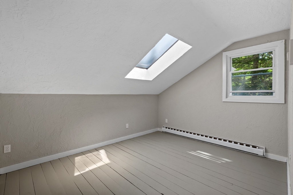 254 Adams Road Oakham, MA 01068 - Photo 14 of 29 a view of an empty room with wooden floor and a window