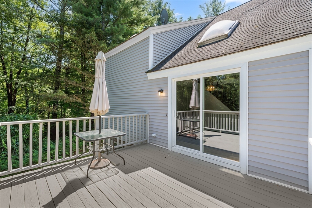 254 Adams Road Oakham, MA 01068 - Photo 19 of 29 a view of a wooden deck with a bench