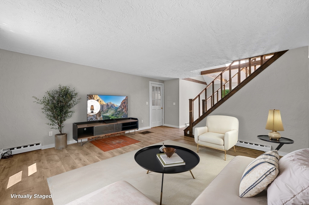 254 Adams Road Oakham, MA 01068 - Photo 2 of 29 a living room with furniture and a flat screen tv