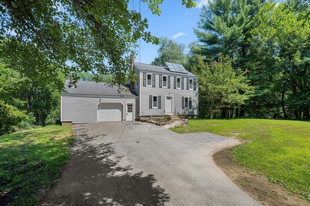 254 Adams Road Oakham, MA 01068 - Photo 26 of 29 a view of a house with a yard and large tree