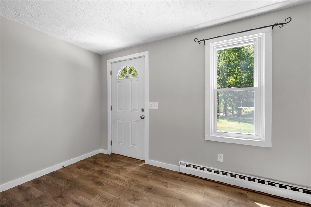 254 Adams Road Oakham, MA 01068 - Photo 4 of 29 a view of an empty room with a window