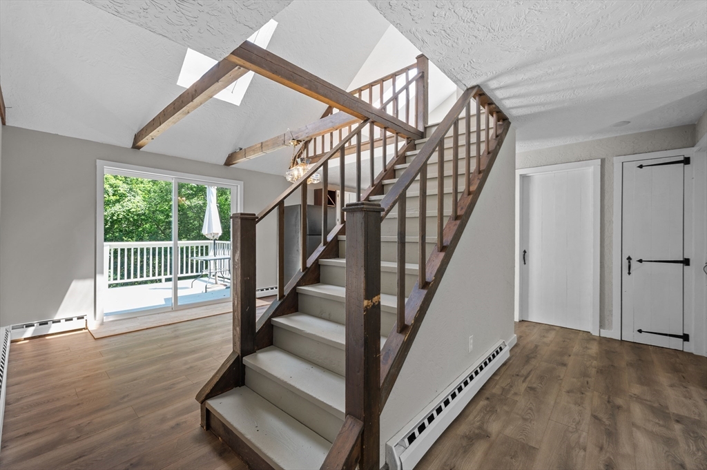 254 Adams Road Oakham, MA 01068 - Photo 6 of 29 a view of entryway with wooden floor and stairs