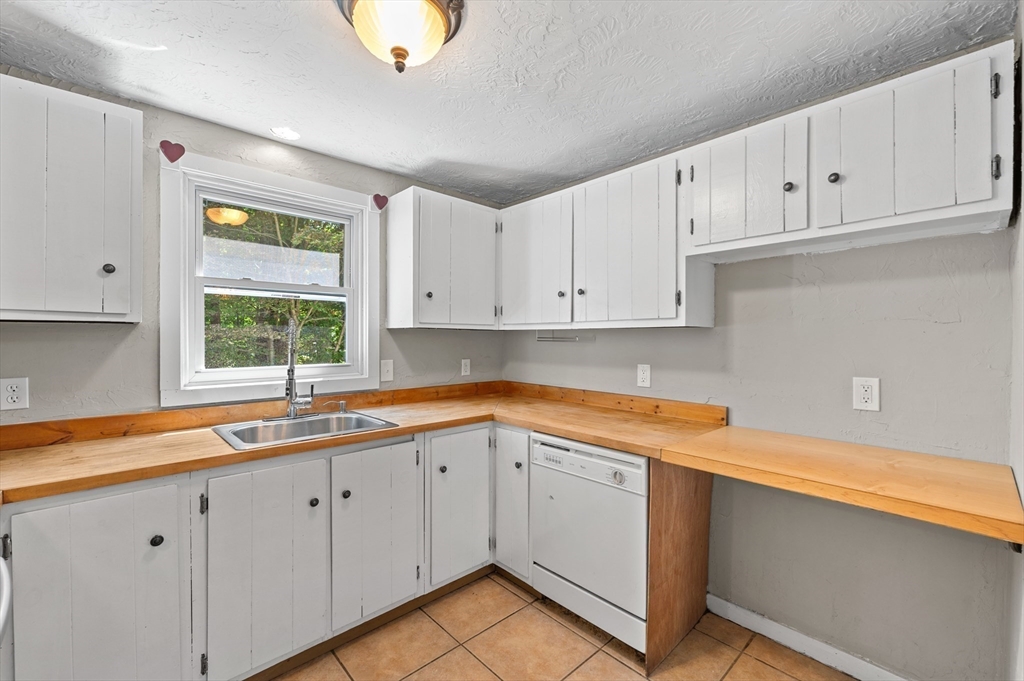 254 Adams Road Oakham, MA 01068 - Photo 10 of 29 a kitchen with white cabinets and a sink