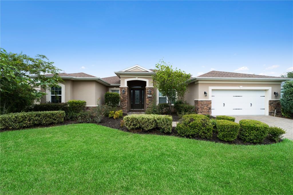4417 Southwest 65th Place Ocala, FL 34474 - Photo 1 of 1 a front view of a house with a garden and plants